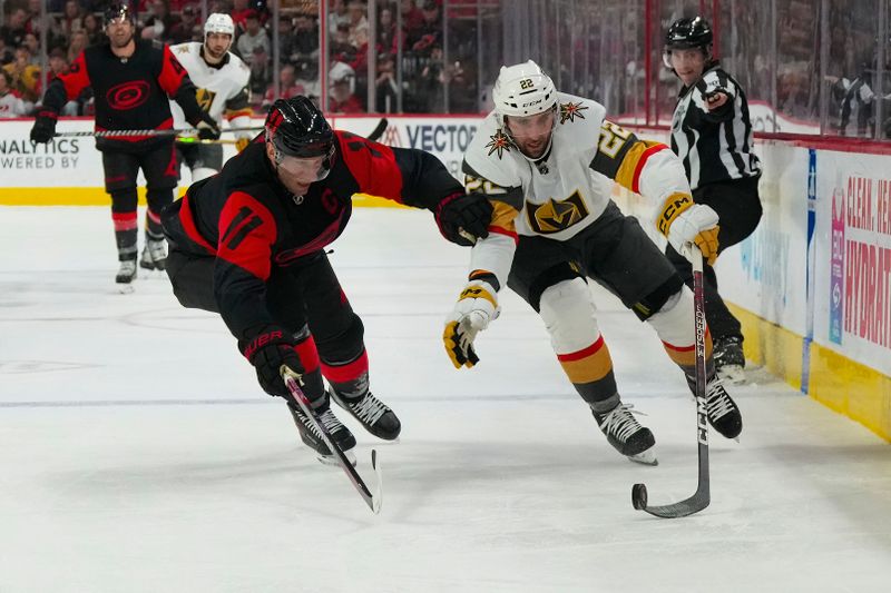 Mar 11, 2023; Raleigh, North Carolina, USA;  Vegas Golden Knights right wing Michael Amadio (22) tries to skate with the puck past Carolina Hurricanes center Jordan Staal (11) during the second period at PNC Arena. Mandatory Credit: James Guillory-USA TODAY Sports