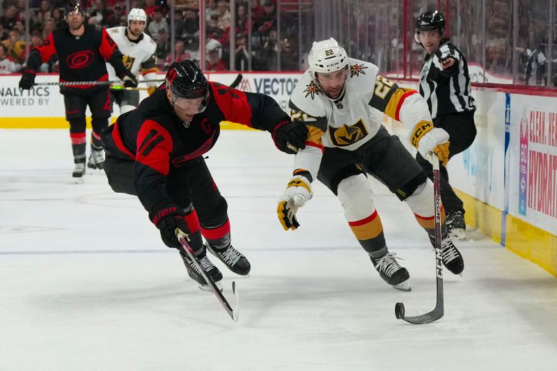 Mar 11, 2023; Raleigh, North Carolina, USA;  Vegas Golden Knights right wing Michael Amadio (22) tries to skate with the puck past Carolina Hurricanes center Jordan Staal (11) during the second period at PNC Arena. Mandatory Credit: James Guillory-USA TODAY Sports