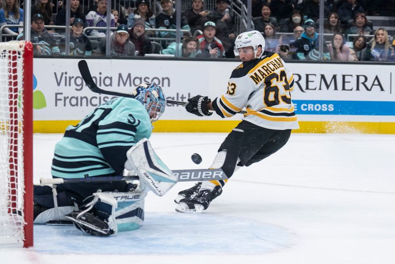 Feb 23, 2023; Seattle, Washington, USA; Boston Bruins forward Brad Marchand (63) takes a shot on Seattle Kraken goalie Philipp Grubauer (31) during the second period at Climate Pledge Arena. Mandatory Credit: Stephen Brashear-USA TODAY Sports