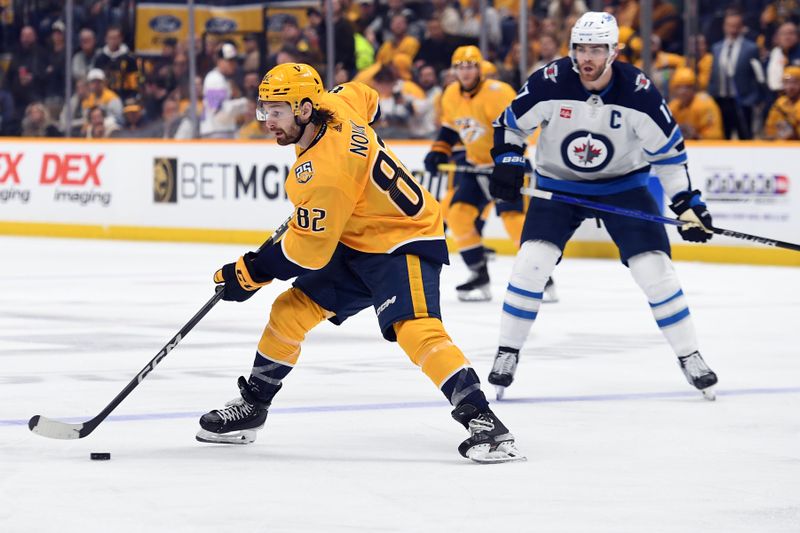 Apr 9, 2024; Nashville, Tennessee, USA; Nashville Predators center Tommy Novak (82) skates with the puck during the third period against the Winnipeg Jets at Bridgestone Arena. Mandatory Credit: Christopher Hanewinckel-USA TODAY Sports