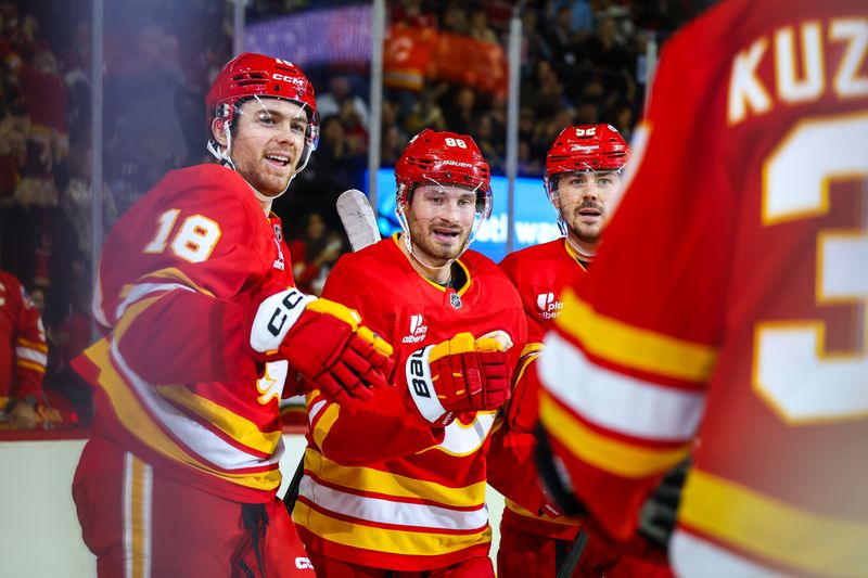 Dec 20, 2025; Calgary, Alberta, CAN; Calgary Flames left wing Joel Farabee (86) celebrates his goal with teammates against the Vegas Golden Knights during the second period at Scotiabank Saddledome. Mandatory Credit: Sergei Belski-Imagn Images
