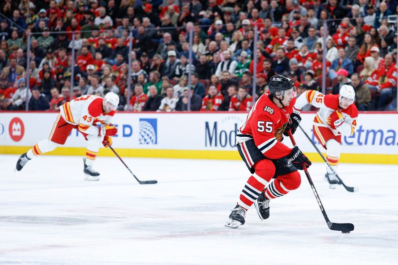 Nov 18, 2025; Chicago, Illinois, USA; Chicago Blackhawks defenseman Artyom Levshunov (55) looks to pass the puck against the Calgary Flames during the second period at United Center. Mandatory Credit: Kamil Krzaczynski-Imagn Images