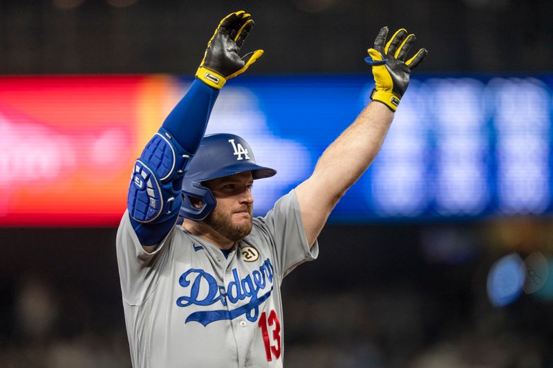 Sep 15, 2023; Seattle, Washington, USA; Los Angeles Dodgers third baseman Max Muncy (13) celebrates after hitting an RBI-triple during the sixth inning against the Seattle Mariners at T-Mobile Park. Mandatory Credit: Stephen Brashear-USA TODAY Sports