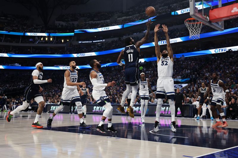 DALLAS, TEXAS - MAY 26: Kyrie Irving #11 of the Dallas Mavericks shoots the ball between Mike Conley #10 and Karl-Anthony Towns #32 of the Minnesota Timberwolves during the second quarter in Game Three of the Western Conference Finals at American Airlines Center on May 26, 2024 in Dallas, Texas. NOTE TO USER: User expressly acknowledges and agrees that, by downloading and or using this photograph, User is consenting to the terms and conditions of the Getty Images License Agreement. (Photo by Matthew Stockman/Getty Images)