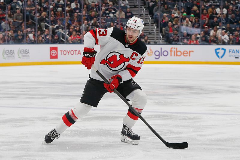 Dec 31, 2025; Columbus, Ohio, USA; New Jersey Devils center Nico Hischier (13) looks to pass against the Columbus Blue Jackets during the first period at Nationwide Arena. Mandatory Credit: Russell LaBounty-Imagn Images