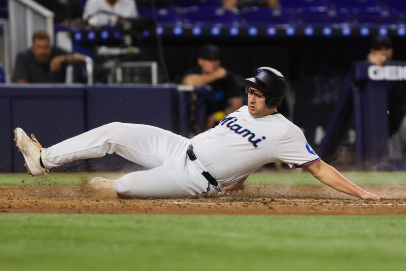 Sep 4, 2024; Miami, Florida, USA; Miami Marlins designated hitter Jonah Bride (41) slides at home plate and scores against the Washington Nationals during the seventh inning at loanDepot Park. Mandatory Credit: Sam Navarro-Imagn Images