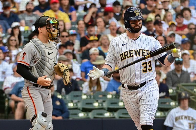 May 27, 2023; Milwaukee, Wisconsin, USA;  Milwaukee Brewers designated hitter Jesse Winker (33) reacts after striking out in the fourth inning as San Francisco Giants catcher Patrick Bailey (14) looks on at American Family Field. Mandatory Credit: Benny Sieu-USA TODAY Sports