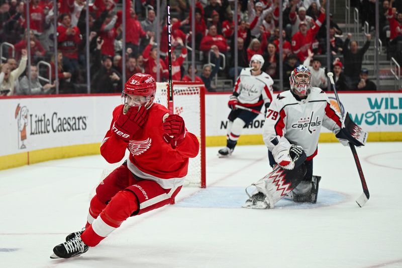 Feb 27, 2024; Detroit, Michigan, USA; Detroit Red Wings left wing J.T. Compher (37) celebrates his goal as Washington Capitals goaltender Charlie Lindgren (79) reacts during the second period at Little Caesars Arena. Mandatory Credit: Tim Fuller-USA TODAY Sports