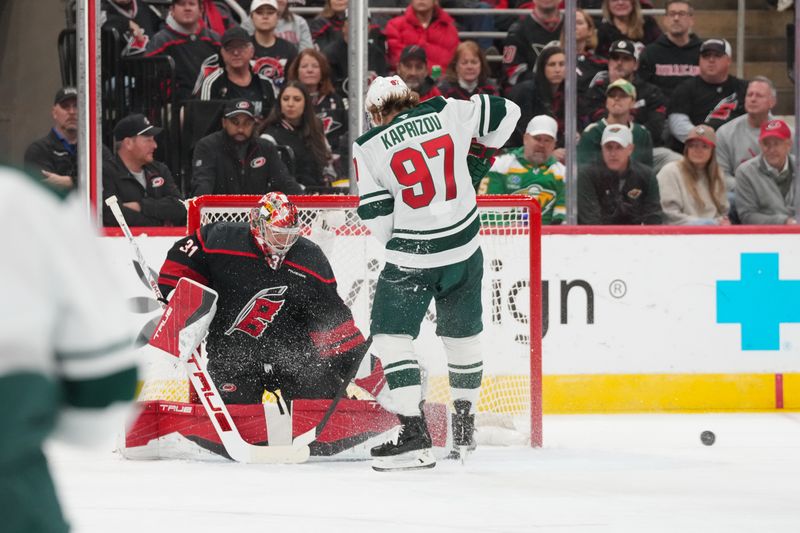 Nov 6, 2025; Raleigh, North Carolina, USA;  Carolina Hurricanes goaltender Frederik Andersen (31) stops the shot in front of Minnesota Wild left wing Kirill Kaprizov (97) during the first period at Lenovo Center. Mandatory Credit: James Guillory-Imagn Images