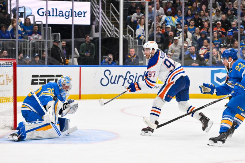 Mar 13, 2026; St. Louis, Missouri, USA; St. Louis Blues goaltender Joel Hofer (30) makes a save against Edmonton Oilers center Connor McDavid (97) during the third period at Enterprise Center. Mandatory Credit: Jeff Curry-Imagn Images