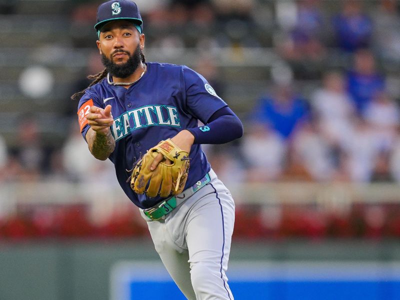 Jun 25, 2025; Minneapolis, Minnesota, USA; Seattle Mariners shortstop J.P. Crawford (3) throws to first base against the Minnesota Twins in the sixth inning at Target Field. Mandatory Credit: Brad Rempel-Imagn Images
