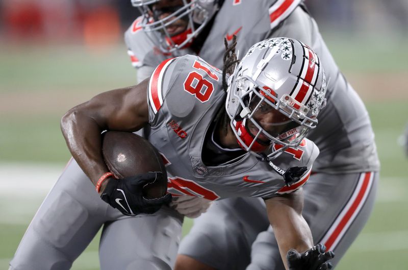 Nov 11, 2023; Columbus, Ohio, USA;  Ohio State Buckeyes wide receiver Marvin Harrison Jr. (18) scores the touchdown during the first quarter against the Michigan State Spartans at Ohio Stadium. Mandatory Credit: Joseph Maiorana-USA TODAY Sports