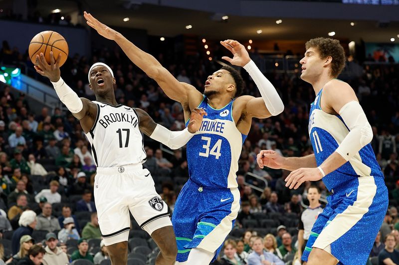 MILWAUKEE, WISCONSIN - MARCH 21: Dennis Schroder #17 of the Brooklyn Nets drives to the basket on Giannis Antetokounmpo #34 of the Milwaukee Bucks during the second half of the game at Fiserv Forum on March 21, 2024 in Milwaukee, Wisconsin. NOTE TO USER: User expressly acknowledges and agrees that, by downloading and or using this photograph, User is consenting to the terms and conditions of the Getty Images License Agreement. (Photo by John Fisher/Getty Images)