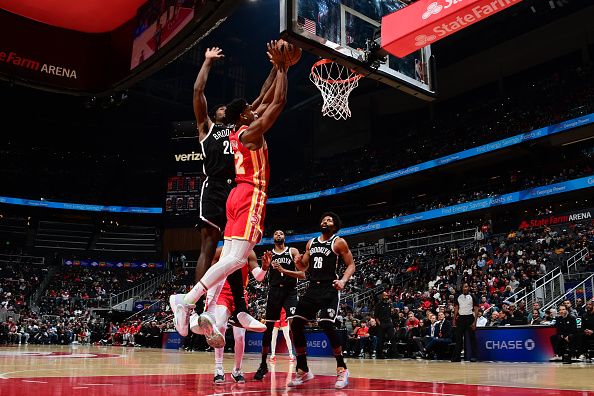 ATLANTA, GA - DECEMBER 6: De'Andre Hunter #12 of the Atlanta Hawks drives to the basket during the game against the Brooklyn Nets on December 6, 2023 at State Farm Arena in Atlanta, Georgia.  NOTE TO USER: User expressly acknowledges and agrees that, by downloading and/or using this Photograph, user is consenting to the terms and conditions of the Getty Images License Agreement. Mandatory Copyright Notice: Copyright 2023 NBAE (Photo by Scott Cunningham/NBAE via Getty Images)