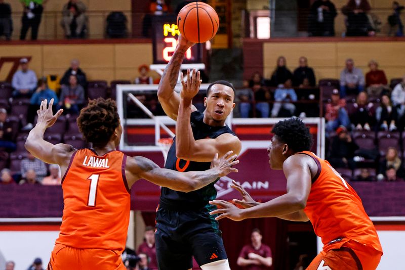 Jan 4, 2025; Blacksburg, Virginia, USA; Miami Hurricanes guard Matthew Cleveland (0) passes the ball against Virginia Tech Hokies forward Tobi Lawal (1) and Virginia Tech Hokies guard Rodney Brown Jr. (4) during the second half at Cassell Coliseum. Mandatory Credit: Peter Casey-Imagn Images