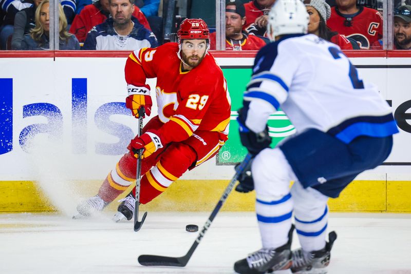 Oct 11, 2023; Calgary, Alberta, CAN; Calgary Flames center Dillon Dube (29) controls the puck against the Winnipeg Jets during the second period at Scotiabank Saddledome. Mandatory Credit: Sergei Belski-USA TODAY Sports