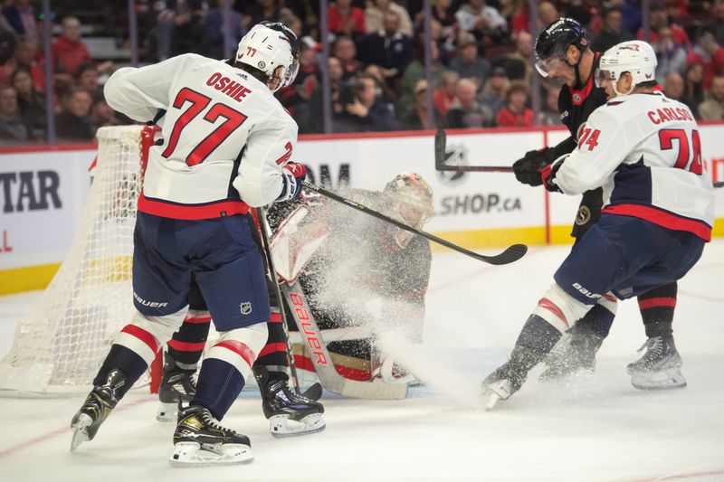 Oct 18, 2023; Ottawa, Ontario, CAN; Ottawa Senators goalie Anton Forsberg (31) gets a shower from Washington Capitals defenseman John Carlson (74) in the second period at the Canadian Tire Centre. Mandatory Credit: Marc DesRosiers-USA TODAY Sports