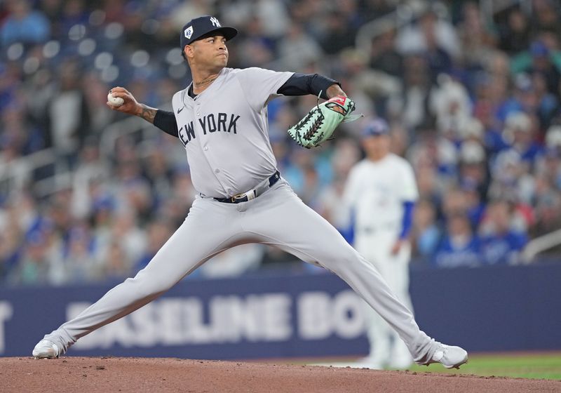 Apr 15, 2024; Toronto, Ontario, CAN; New York Yankees pitcher Luis Gil wearing number 42 for Jackie Robinson Day throws a pitch against the Toronto Blue Jays during the first inning at Rogers Centre. Mandatory Credit: Nick Turchiaro-USA TODAY Sports