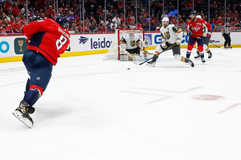 Oct 15, 2024; Washington, District of Columbia, USA; Washington Capitals left wing Alex Ovechkin (8) shoots the puck on Vegas Golden Knights goaltender Adin Hill (33) as Golden Knights defenseman Alex Pietrangelo (7) defends in the first period at Capital One Arena. Mandatory Credit: Geoff Burke-Imagn Images