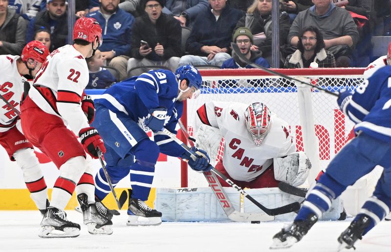 Dec 30, 2023; Toronto, Ontario, CAN; Carolina Hurricanes goalie Pyotr Kochetkov (52) makes a save on a shot from Toronto Maple Leafs forward John Tavares (91) in the second period at Scotiabank Arena. Mandatory Credit: Dan Hamilton-USA TODAY Sports