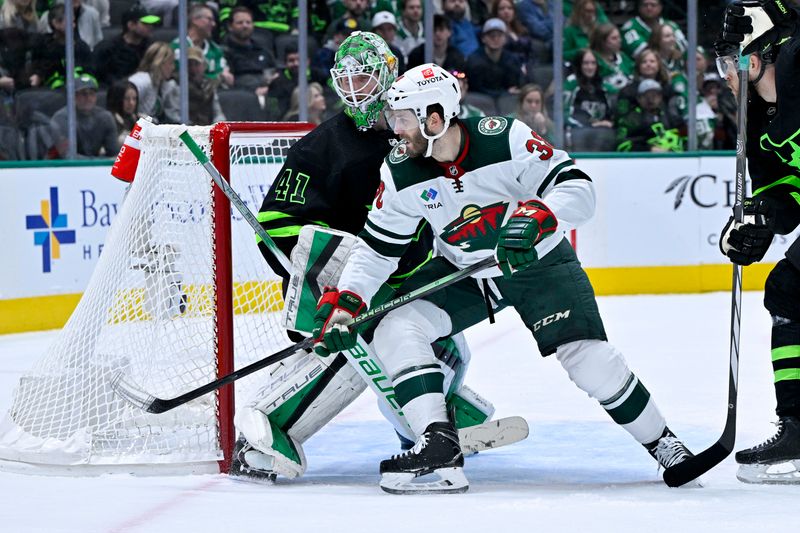 Jan 10, 2024; Dallas, Texas, USA; Minnesota Wild right wing Ryan Hartman (38) chases the puck past Dallas Stars goaltender Scott Wedgewood (41) during the third period at the American Airlines Center. Mandatory Credit: Jerome Miron-USA TODAY Sports