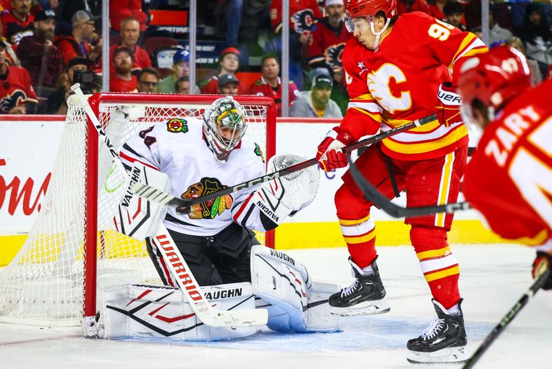 Oct 15, 2024; Calgary, Alberta, CAN; Chicago Blackhawks goaltender Petr Mrazek (34) makes a save against Calgary Flames left wing Andrei Kuzmenko (96) during the second period at Scotiabank Saddledome. Mandatory Credit: Sergei Belski-Imagn Images