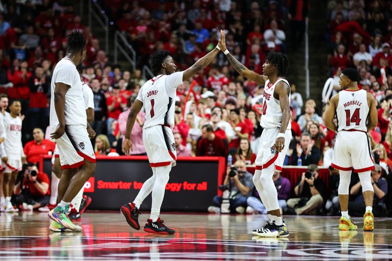 Feb 19, 2023; Raleigh, North Carolina, USA;  North Carolina State Wolfpack guard Jarkel Joiner (1) and guard Terquavion Smith (0) celebrate during the second half of the game against North Carolina Tar Heels at PNC Arena. Mandatory Credit: Jaylynn Nash-USA TODAY Sports