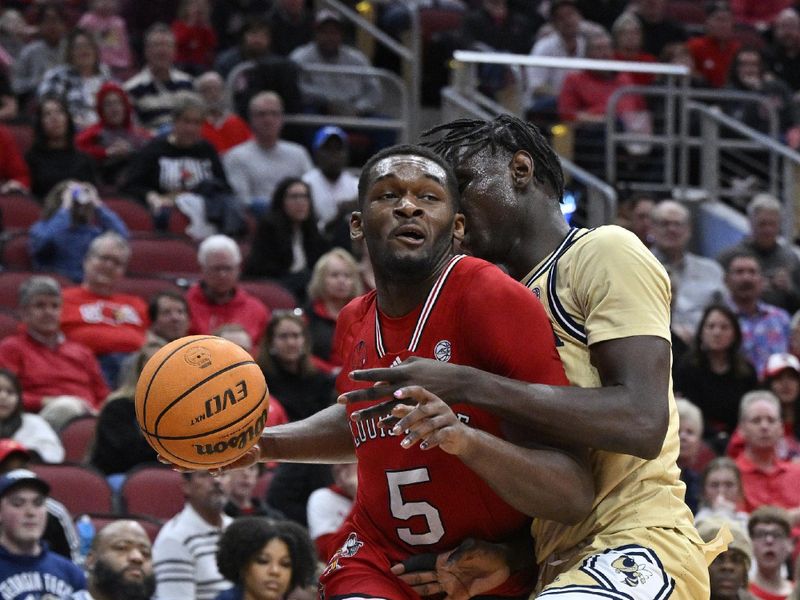 Feb 10, 2024; Louisville, Kentucky, USA; Louisville Cardinals forward Brandon Huntley-Hatfield (5) drives to the basket against Georgia Tech Yellow Jackets forward Baye Ndongo (11) during the second half at KFC Yum! Center. Louisville defeated Georgia Tech 79-67. Mandatory Credit: Jamie Rhodes-USA TODAY Sports