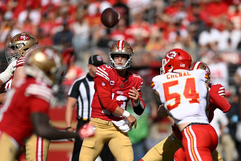 San Francisco 49ers quarterback Brock Purdy, middle, passes against the Kansas City Chiefs during the first half of an NFL football game in Santa Clara, Calif., Sunday, Oct. 20, 2024. (AP Photo/Eakin Howard)