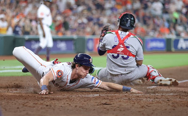 Jul 4, 2023; Houston, Texas, USA; Houston Astros center fielder Jake Meyers (6) slides safely to score a run past Colorado Rockies catcher Elias Diaz (35) during the fifth inning at Minute Maid Park. Mandatory Credit: Troy Taormina-USA TODAY Sports