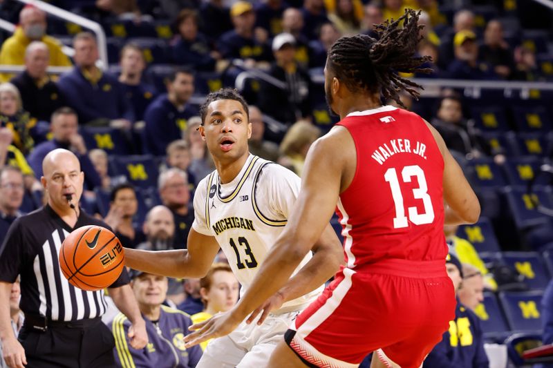 Feb 8, 2023; Ann Arbor, Michigan, USA;  Michigan Wolverines guard Jett Howard (13) defended by defended by Nebraska Cornhuskers forward Derrick Walker (13) in the first half at Crisler Center. Mandatory Credit: Rick Osentoski-USA TODAY Sports