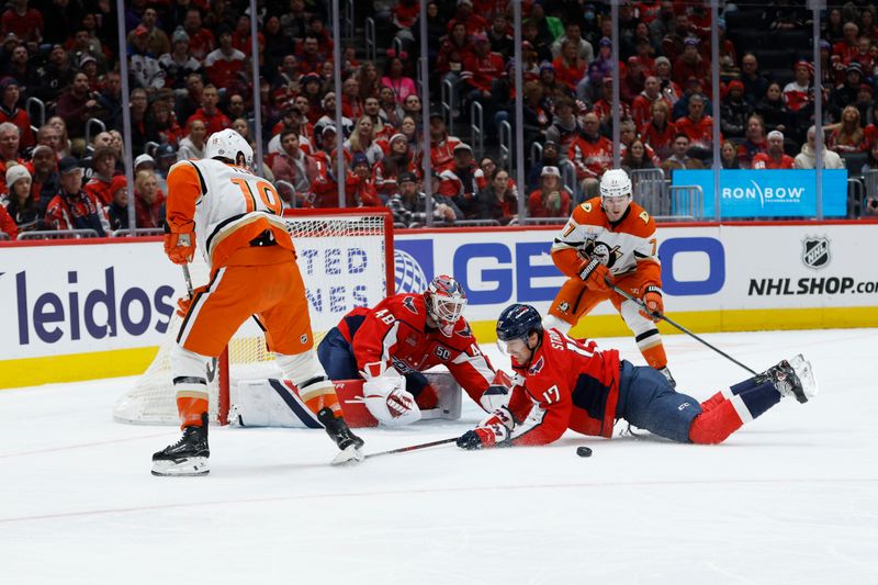 Jan 14, 2025; Washington, District of Columbia, USA; Washington Capitals center Dylan Strome (17) dives to block pass by Anaheim Ducks right wing Troy Terry (19) in front of Washington Capitals goaltender Logan Thompson (48) in the second period at Capital One Arena. Mandatory Credit: Geoff Burke-Imagn Images