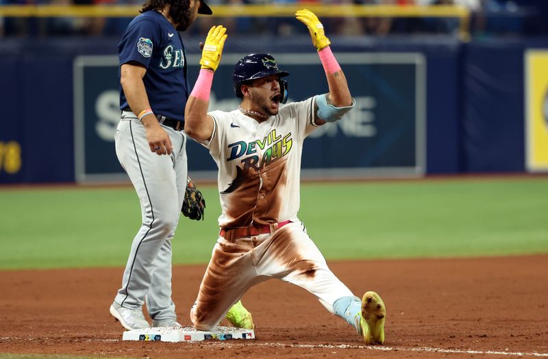 Sep 8, 2023; St. Petersburg, Florida, USA; Tampa Bay Rays center fielder Jose Siri (22) celebrates after he triples during the eighth inning against the Seattle Mariners  at Tropicana Field. Mandatory Credit: Kim Klement Neitzel-USA TODAY Sports