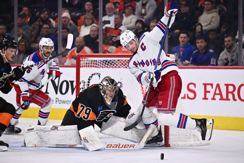 Nov 24, 2023; Philadelphia, Pennsylvania, USA; Philadelphia Flyers goalie Carter Hart (79) and New York Rangers defenseman Zac Jones (6) battle for the puck in the third period at Wells Fargo Center. Mandatory Credit: Kyle Ross-USA TODAY Sports