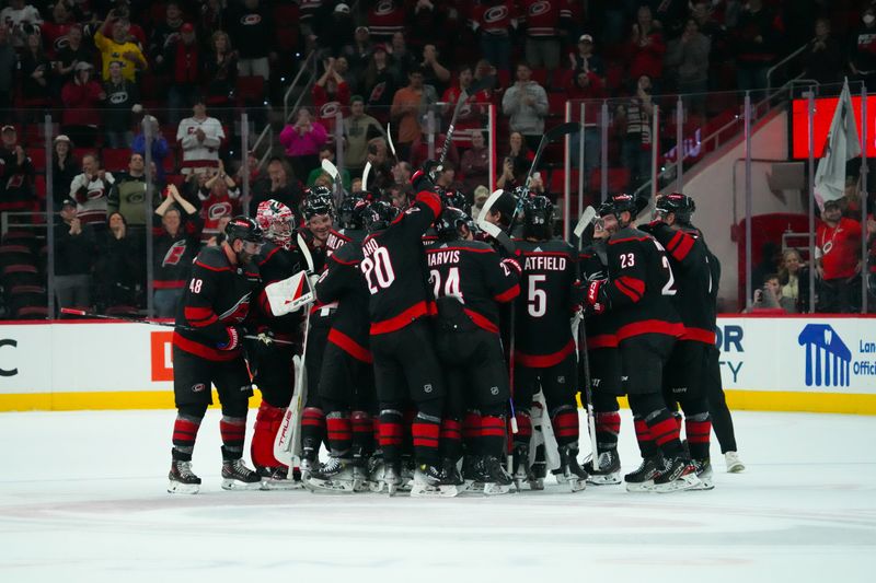 Mar 14, 2024; Raleigh, North Carolina, USA; Carolina Hurricanes players celebrates their win against the Florida Panthers at PNC Arena. Mandatory Credit: James Guillory-USA TODAY Sports