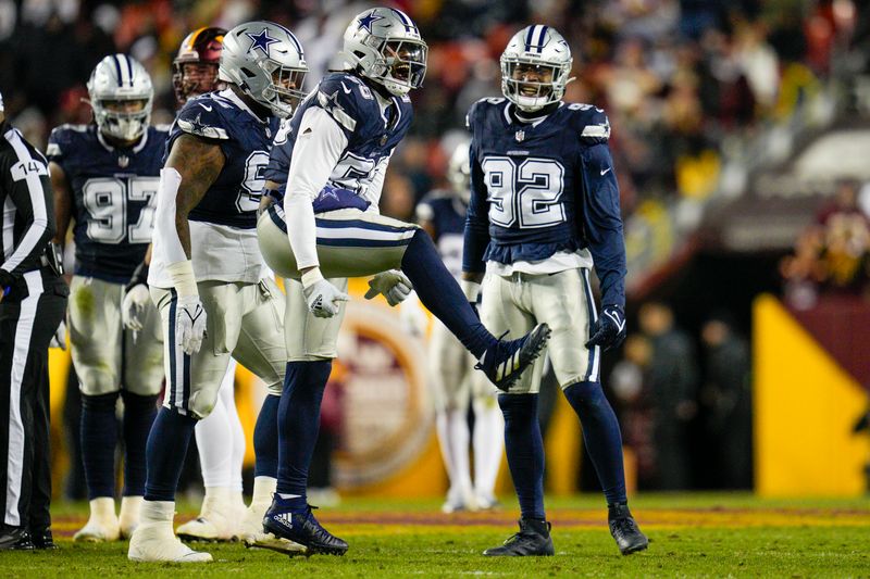 Dallas Cowboys defensive end Dante Fowler Jr. (56) celebrates with defensive tackle Johnathan Hankins (95) and defensive end Dorance Armstrong (92) after sacking Washington Commanders quarterback Sam Howell (14) during the first half, Sunday, January 7, 2024, in Landover, Md. Dallas won 38-10. (AP Photo/Jess Rapfogel)