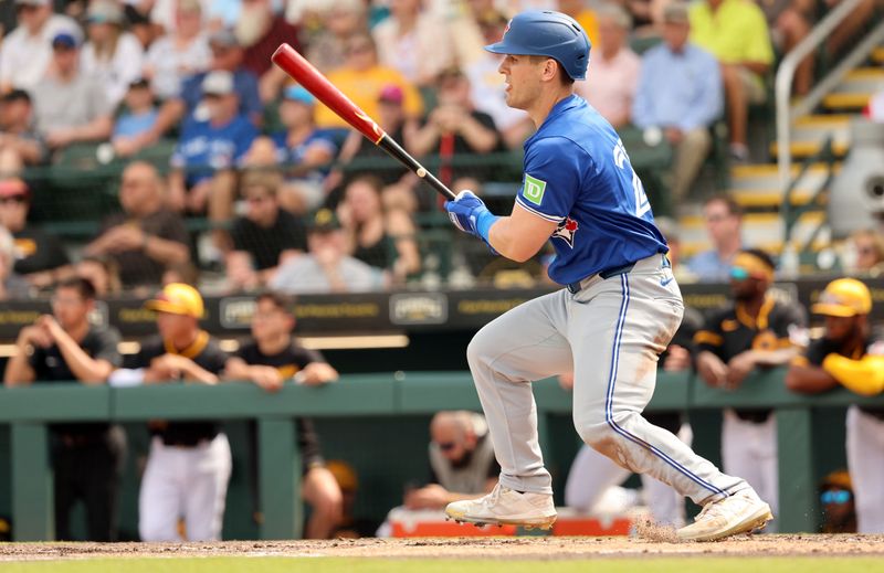 Mar 5, 2024; Bradenton, Florida, USA;  Toronto Blue Jays left fielder Daulton Varsho (25) hits a sacrifice RBI during the third inning against the Pittsburgh Pirates at LECOM Park. Mandatory Credit: Kim Klement Neitzel-USA TODAY Sports