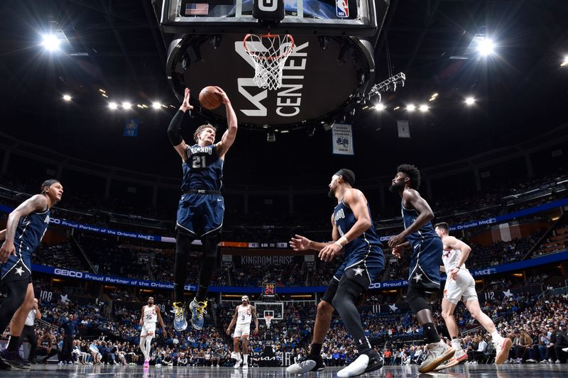 ORLANDO, FL - JANUARY 28: Moritz Wagner #21 of the Orlando Magic grabs the rebound during the game on January 28, 2024 at Amway Center in Orlando, Florida. NOTE TO USER: User expressly acknowledges and agrees that, by downloading and or using this photograph, User is consenting to the terms and conditions of the Getty Images License Agreement. Mandatory Copyright Notice: Copyright 2024 NBAE (Photo by Fernando Medina/NBAE via Getty Images)