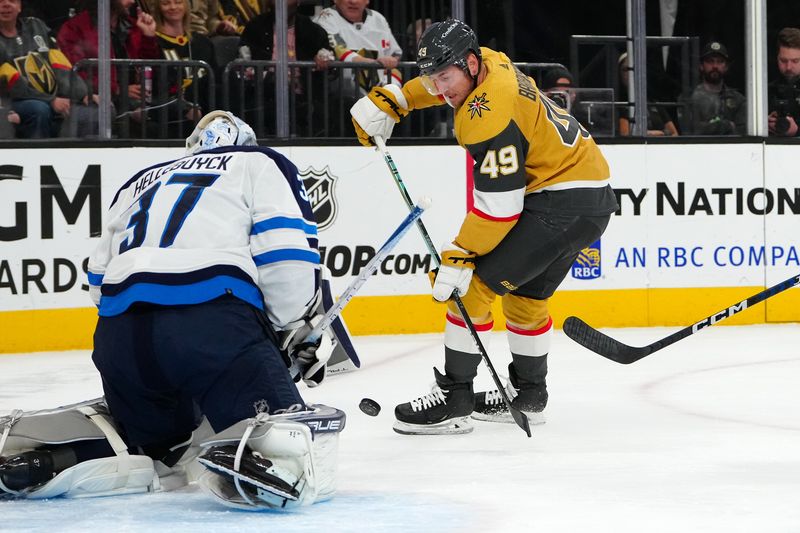 Nov 2, 2023; Las Vegas, Nevada, USA; Winnipeg Jets goaltender Connor Hellebuyck (37) makes a save against Vegas Golden Knights center Ivan Barbashev (49) during the first period at T-Mobile Arena. Mandatory Credit: Stephen R. Sylvanie-USA TODAY Sports