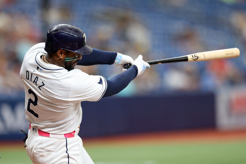 Sep 5, 2024; St. Petersburg, Florida, USA; Tampa Bay Rays first baseman Yandy Diaz (2) hits an rbi double against the Minnesota Twins in the seventh inning at Tropicana Field. Mandatory Credit: Nathan Ray Seebeck-Imagn Images