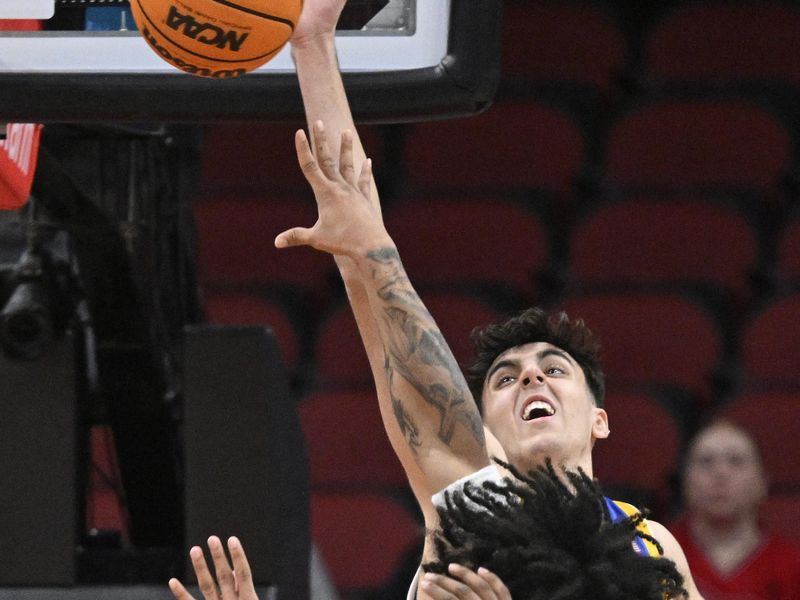 Jan 6, 2024; Louisville, Kentucky, USA;  Pittsburgh Panthers forward Guillermo Diaz Graham (25) blocks the shot of Louisville Cardinals guard Skyy Clark (55) during the first half at KFC Yum! Center. Mandatory Credit: Jamie Rhodes-USA TODAY Sports