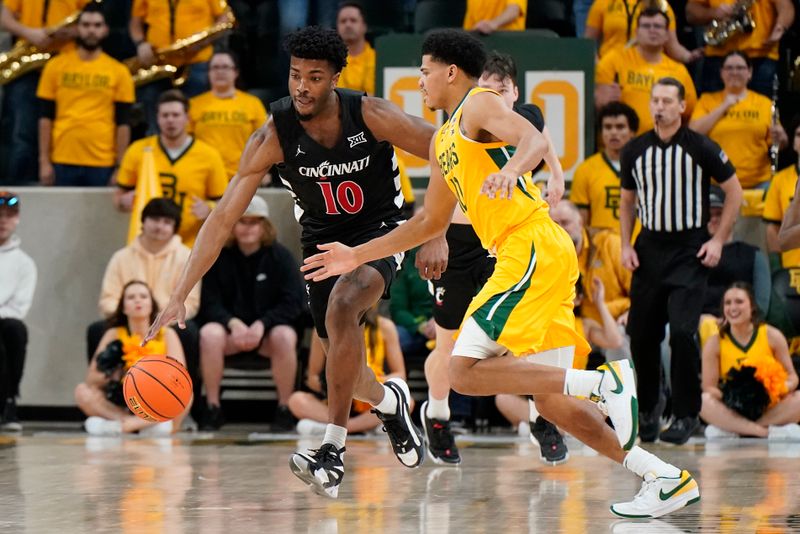 Jan 13, 2024; Waco, Texas, USA; Cincinnati Bearcats guard Josh Reed (10) makes the steal from Baylor Bears guard RayJ Dennis (10) during the first half at Paul and Alejandra Foster Pavilion. Mandatory Credit: Raymond Carlin III-USA TODAY Sports