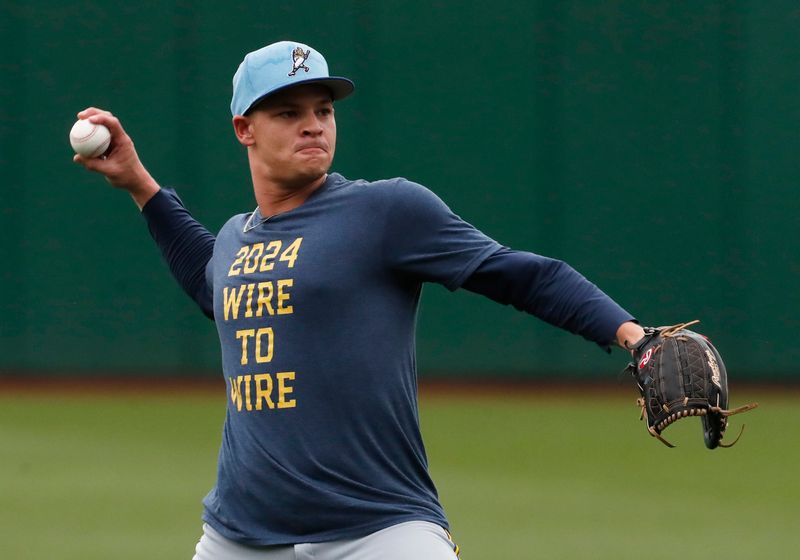 Sep 26, 2024; Pittsburgh, Pennsylvania, USA;  Milwaukee Brewers pitcher Tobias Myers (36) warms up in the outfield before a game against the Pittsburgh Pirates at PNC Park. Mandatory Credit: Charles LeClaire-Imagn Images