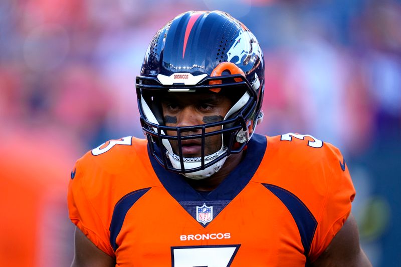 Denver Broncos quarterback Russell Wilson (3) warms up prior to an NFL preseason football game against the Minnesota Vikings, Saturday, Aug. 27, 2022, in Denver. (AP Photo/Jack Dempsey)