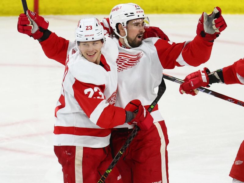 Jan 17, 2023; Tempe, Arizona, USA; Detroit Red Wings center Dylan Larkin (71) celebrates a goal with left wing Lucas Raymond (23) against the Arizona Coyotes in the second period at Mullett Arena. Mandatory Credit: Mark J. Rebilas-USA TODAY Sports