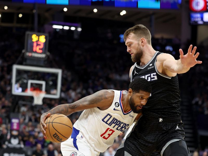 SACRAMENTO, CALIFORNIA - MARCH 03: Paul George #13 of the LA Clippers is guarded by Domantas Sabonis #10 of the Sacramento Kings at Golden 1 Center on March 03, 2023 in Sacramento, California. NOTE TO USER: User expressly acknowledges and agrees that, by downloading and or using this photograph, User is consenting to the terms and conditions of the Getty Images License Agreement.   (Photo by Ezra Shaw/Getty Images)