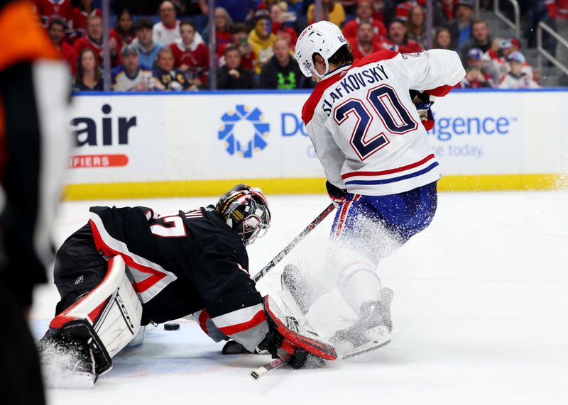 Dec 9, 2023; Buffalo, New York, USA;  Montreal Canadiens left wing Juraj Slafkovsky (20) scores a goal on Buffalo Sabres goaltender Devon Levi (27) to win the game in a shootout at KeyBank Center. Mandatory Credit: Timothy T. Ludwig-USA TODAY Sports