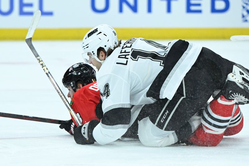 Mar 3, 2025; Chicago, Illinois, USA;  Los Angeles Kings right wing Alex Laferriere (14) falls on Chicago Blackhawks center Ryan Donato (8) during the first period at the United Center. Mandatory Credit: Matt Marton-Imagn Images