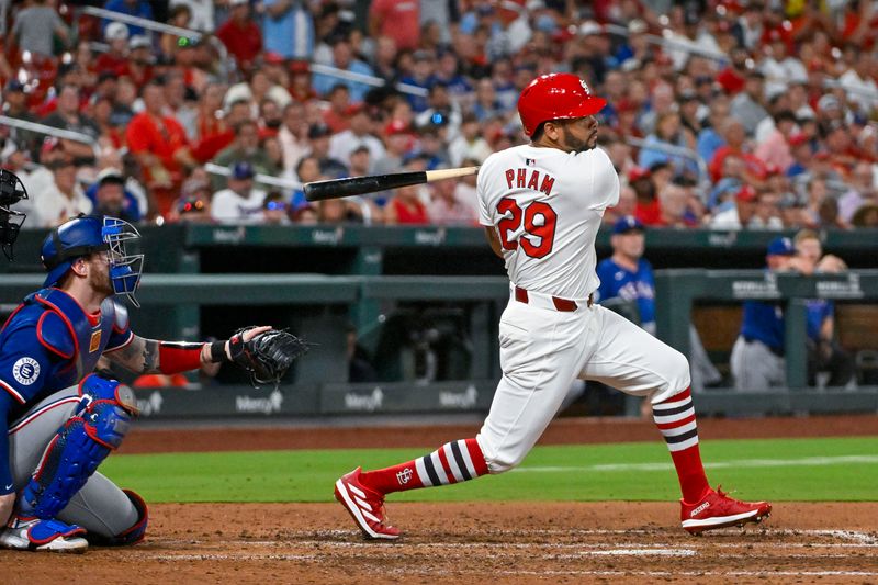 Jul 30, 2024; St. Louis, Missouri, USA;  St. Louis Cardinals pinch hitter Tommy Pham (29) hits a grand slam home run against the Texas Rangers during the fifth inning at Busch Stadium. Mandatory Credit: Jeff Curry-USA TODAY Sports