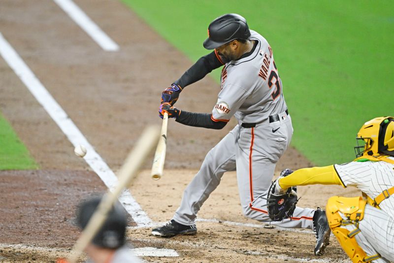 Apr 29, 2025; San Diego, California, USA; San Francisco Giants first baseman LaMonte Wade Jr. (31) hits an RBI triple during the sixth inning against the San Diego Padres at Petco Park. Mandatory Credit: Denis Poroy-Imagn Images